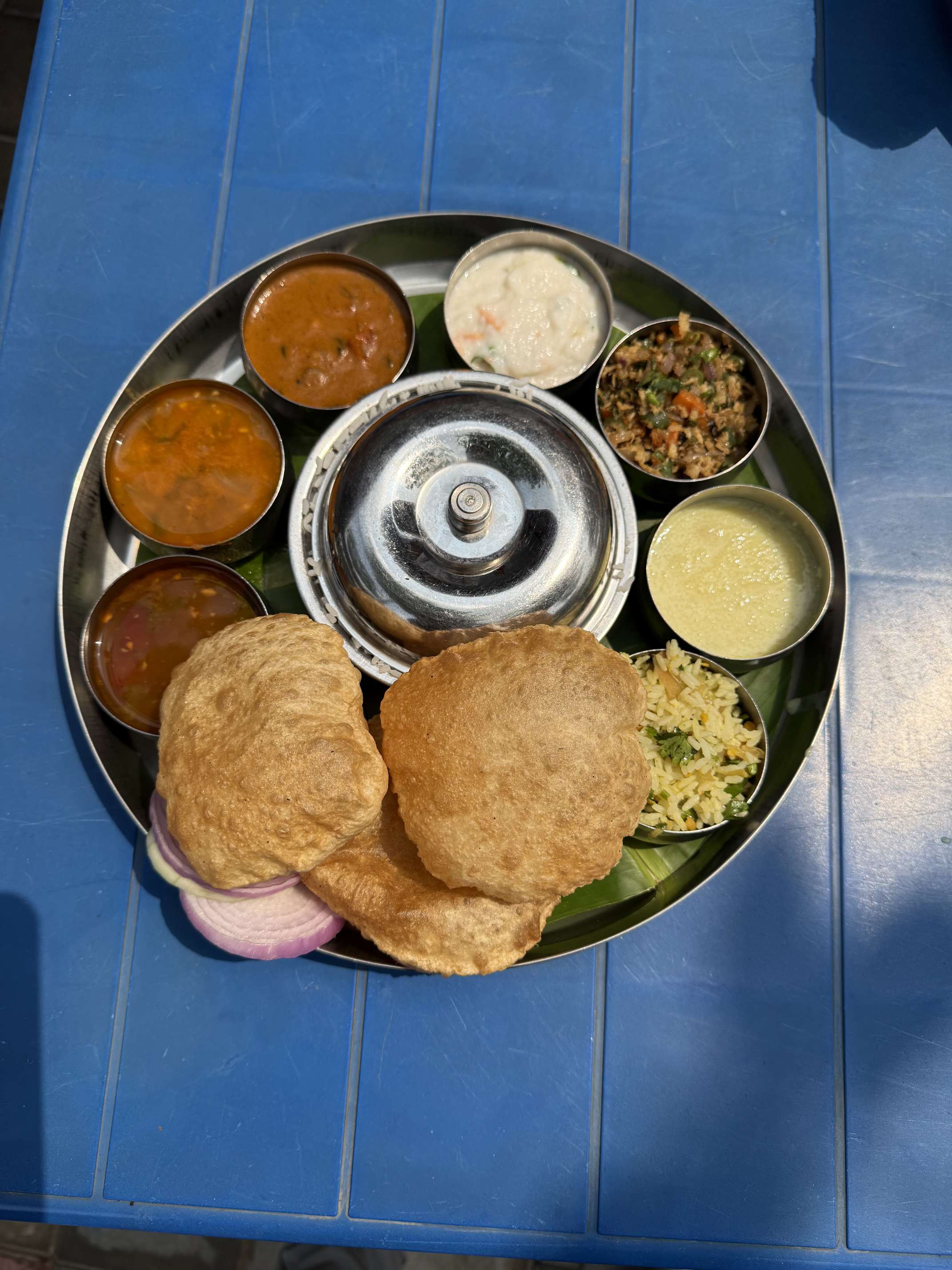 South Indian thali served on banana leaf with rice and sambar